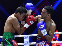 Omar Elquers of Morocco (blue) punches Wanchana Meenayothin of Thailand during the WBC Asia Super Featherweight (130 LBS.) title bout at Ran...