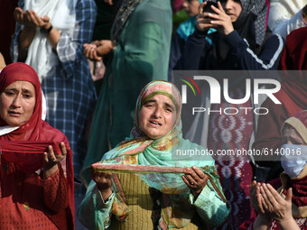 A Kashmiri muslim woman prays on the occasion of celebration of Mawlid-un-Nabi or Prophet Muhammad's (PBUH) birth anniversary in Dargah Hazr...