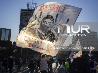 A person holds a flag with an image allusive to the freedom of prisoners on October 30, 2020 in Santiago de Chile, Chile. 
Amid of the demo...