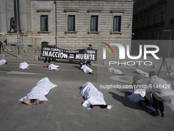 X-Rebellion activists  as perform a die-in protest against climate change during all Saints' Day outside the Spanish Parliament in Madrid, S...