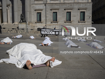 X-Rebellion activists  as perform a die-in protest against climate change during all Saints' Day outside the Spanish Parliament in Madrid, S...