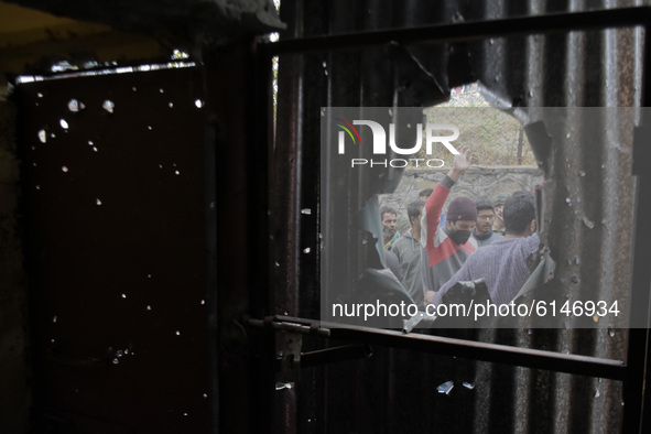 Kashmiri people shout pro freedom slogans outside a damaged residential house in Rangreth area on the outskirts of Srinagar, Kashmir on 01 N...