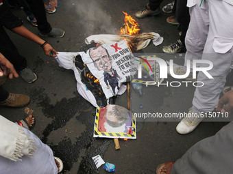 Muslims protest against the Satirical sketches of the Prophet Mohammed burning a picture of the president of France in front France embassy...
