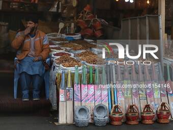 A man selling Dry Fruits and Cricket bats waits for the customers near Qazigund area, in Jammu and Kashmir, India on 01 November 2020 (