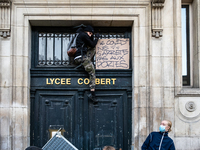 A banner saying ''the covid don 't stop at the doors'' is seen during the students blocked at the entry of their school in Paris, France, on...