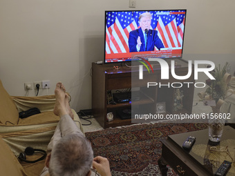 An Iranian man watches television as the U.S. President Donald Trump addresses during a TV program on November 4, 2020 in Tehran, Iran.  (