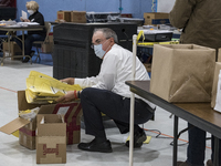 Election official Brian McCoy emptied the ballot counting machine after polls closed at the Bishop Leo E. ONeil Youth Center polling place i...