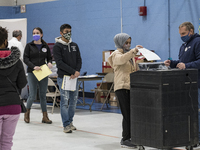 First-time voter Marwah Al Thuwayni, 18, casts her ballot. She was one of about 1000 people who registered to vote at the Bishop Leo E. ONei...