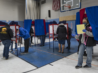 Voters casting their ballots at the Bishop Leo E. ONeil Youth Center Ward 9 polling place in Manchester, New Hampshire, one of the city's bu...