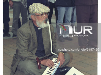 This Pictures taken date is 2003. A Elderly Catholic Priest play instrument during a  anti-war rally about South Korean government Iraq mili...