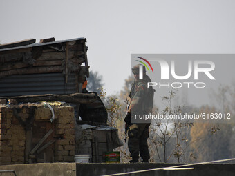 An Indian army soldier looks on during a search operation inside a residential house in Meej area of Pampore in south Kashmir on November 06...