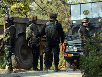 Indian army soldiers stand near the site of gun-battle in Meej area of Pampore in south Kashmir on November 06, 2020. Two militants and a ci...