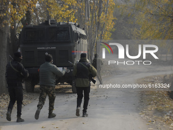 Indian policemen run towards the protesting people near encounter site in Pampore area south of Srinagar, Indian Administered Kashmir on 06...