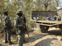 Indian forces collect light apparatus as they prepare to leave from encounter spot in Pampore area south of Srinagar, Indian Administered Ka...