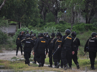 Hundreds of police officers from the Brimob Unit search the location suspected of being the hiding place of two suspected members of the Ter...