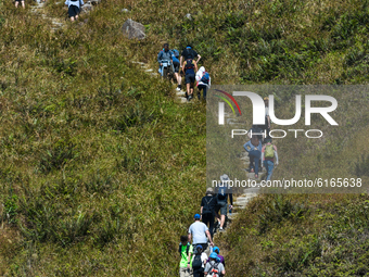 Hikers queue up to climb on Sunset Peak, on the island of Lantau in Hong Kong, China, on November 7, 2020. As temperatures have become fresh...