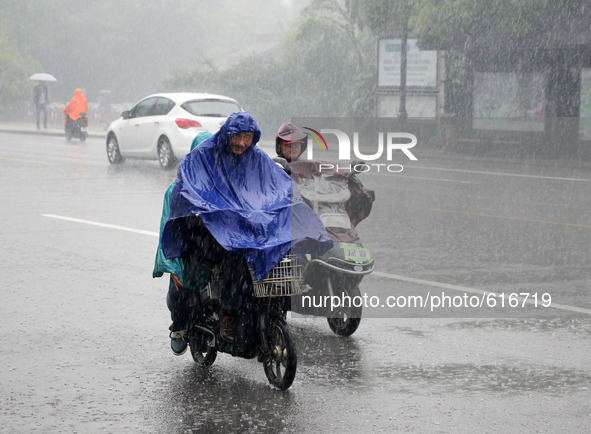 (150602) -- YANGZHOU, June 2, 2015 () -- Residents ride in rain in Yangzhou, east China's Jiangsu Province, June 2, 2015. The National Meteo...