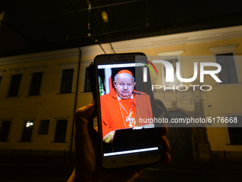 An illustrative photo with a portraitof Cardinal Stanislaw Dziwisz seen on a mobile phone, in front of Krakow Bishops’ Palace in Franciszkan...