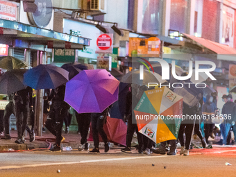 A platoon of protesters forms an ''umbrella phalanx'' to march on the Mongkok police station. On November 12, 2019 in Hong Kong, China. (
