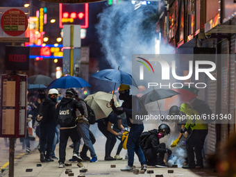 Protesters extinguish tear gas canisters on Nathan road. On November 12, 2019 in Hong Kong, China. (