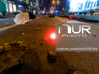 A tear gas canister glows on Nathan road, after a police charge obliged the protsters to retreat, often abandoning their umbrellas. On Novem...