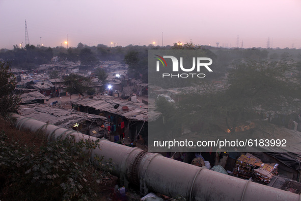 An aerial view of slum neighbourhood engulfed in a layer of smoky haze, as the national capital recorded its air quality in the 'very poor'...