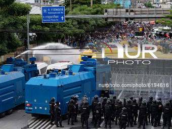 Riot police use water cannons to disperse pro-democracy protesters during a rally outside the Parliament in Bangkok to call for the ouster o...
