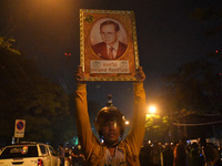 A pro-democracy carries a portrait of the king Bhumibol Adulyadej during a rally outside the Parliament in Bangkok to call for the ouster of...