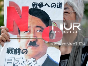 Demonstrators hold banners during a protest against on the security-related legislation near the National Diet building in Tokyo, Japan, 4 J...