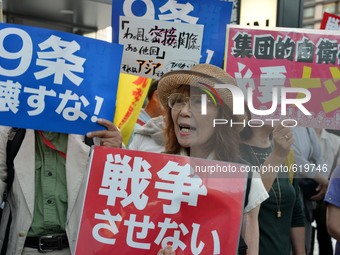Demonstrators hold banners during a protest against on the security-related legislation near the National Diet building in Tokyo, Japan, 4 J...