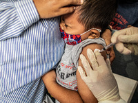 A child crying in his mother arms while received injection. Public Health Cinere held Vaccination with Immunization Basics for Children at A...