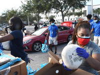 Volunteers distribute food and frozen turkeys to the needy donated by the Second Harvest Food Bank of Central Florida and the City of Orland...