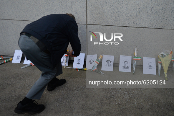A man takes a pictures of images of Bloody Sunday victimes placed outside Croke Park in Dublin during a commemoration event organised by 'Th...