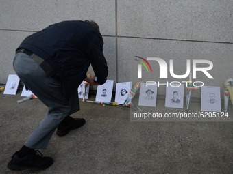 A man takes a pictures of images of Bloody Sunday victimes placed outside Croke Park in Dublin during a commemoration event organised by 'Th...