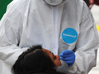 A person undergoes a rapid test to detect the SARS-Cov2 that causes the COVID-19 disease, in a tent installed outside the Etiopia Metro stat...