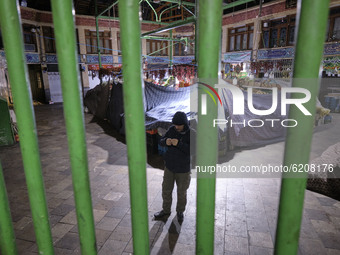 A guard stands in a bazaar which is closed at night as the Capital city is in lockdown for the second time since the new coronavirus disease...