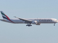 Emirates Boeing 777 aircraft as seen flying, on final approach for landing at Amsterdam Schiphol International Airport AMS EHAM in the Nethe...