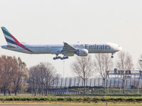 Emirates Boeing 777 aircraft as seen flying, on final approach for landing at Amsterdam Schiphol International Airport AMS EHAM in the Nethe...