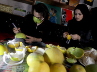 Palestinian artists Samah Said (R) and Dorgham Krakeh (L) are Making protective masks from citrus peels for a project about 
 raising awaren...