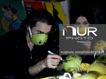Palestinian artists Samah Said (R) and Dorgham Krakeh (L) are Making protective masks from citrus peels for a project about 
 raising awaren...