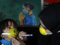 Palestinian artist Samah Said is wearing a protective mask made of citrus peel for a project about raising awareness about the COVID-19 coro...