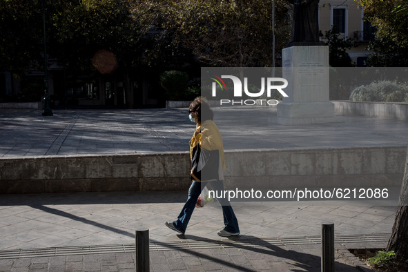 A woman with protected mask seen walking on an empty square in Athens, Greece on November 23, 2020 during the second COVID-19 lockdown in Gr...