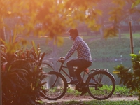 A man rides on a bicycle inside a park amid the COVID-19 coronavirus pandemic in Dhaka, Bangladesh on November 23, 2020.  (