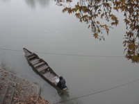 A boatman waits for passengers duirng rainfall in Srinagar, Indian Administered Kashmir on 23 November 2020. The weatherman has pedicted the...