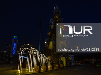 An illuminated decoration in the shape of a Christmas tree, which is commonly used for New Year's celebrations, is placed outside a shopping...