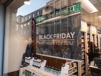 Holland & Barrett shop with Black Friday signs with sale as seen in the front display window of a shop in Eindhoven city center.  Daily life...
