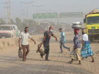 Peoples walk through a dusty busy road in Dhaka, Bangladesh, on November 25, 2020. The air condition of Dhaka city is worsening day by day a...