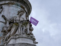 A flag of the trade union organization (Solidaires) at the origin of this demonstration on the statue of Marianne during  a demonstration fo...