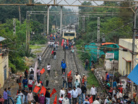Protestors blocked off railway tracks and disrupted local railway services in support of the All India strike, in Kolkata, India, on Novembe...