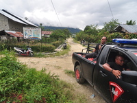 A Mobile Brigade troop car passes around the residents' village in Lembantongoa Village, Palolo District, Sigi Regency, Central Sulawesi Pro...
